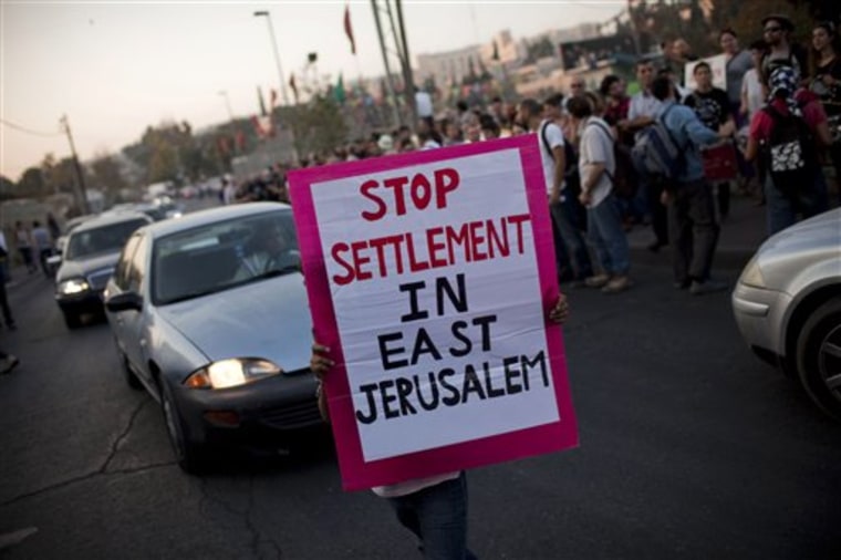 A Palestinian holds a banner during a weekly demonstration supporting Palestinians evicted from their homes in the east Jerusalem neighborhood of Sheikh Jarrah on Nov. 12. 